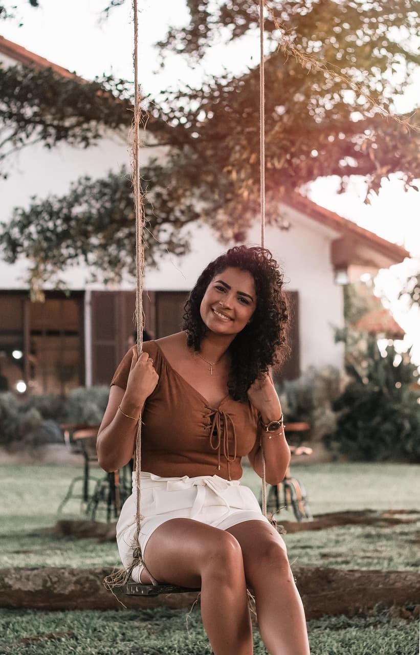 A woman smiling peacefully in warm golden light, at rest and full of hope